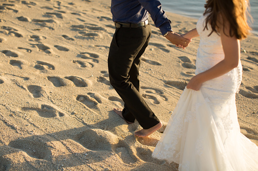 bride and groom walking on the beach of Mauritius