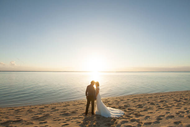 istock bride and groom meet the sunset on the beach. 1391584579