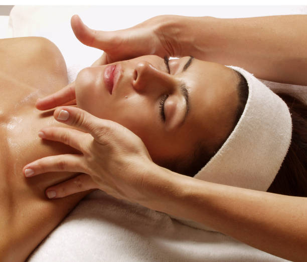 istock woman face massage treatment. 1391585965