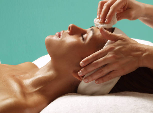 istock woman face cleaning treatment. 1391585980
