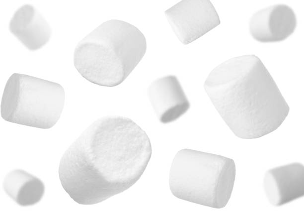 istock Delicious sweet puffy marshmallows flying on white background 1391590063