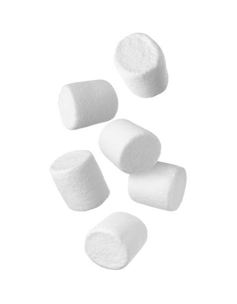 istock Delicious sweet puffy marshmallows flying on white background 1391590066