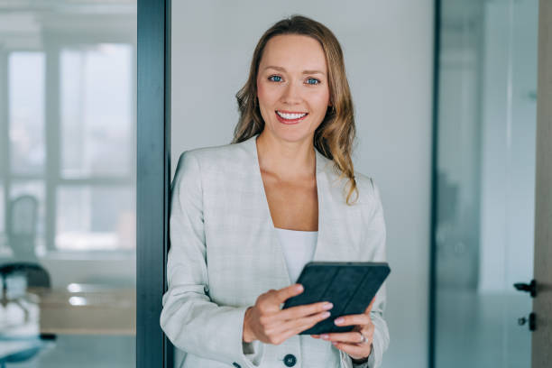 istock Confident businesswoman in modern office. 1391590173