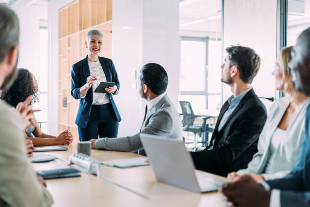 Business persons on meeting in the office. Group of business persons in business meeting. Group of entrepreneurs on meeting in board room. Corporate business team on meeting in the office. staff meeting stock pictures, royalty-free photos & images