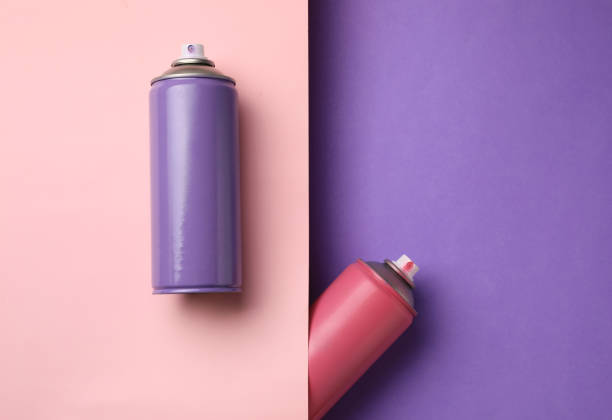 istock Cans of different spray paints on color background, flat lay with space for text. Graffiti supplies 1391590486