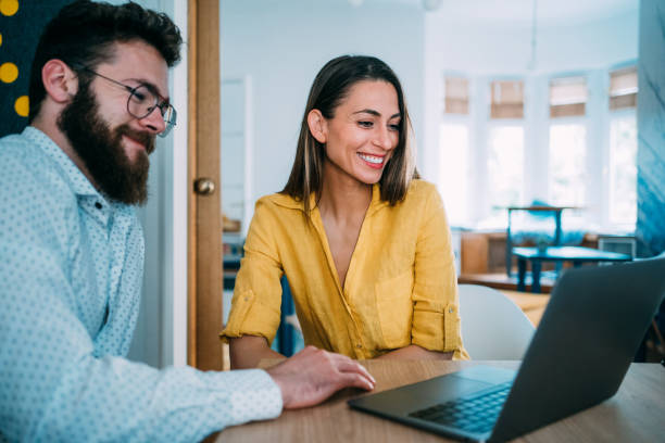 istock Confident business partners working on laptop in office. 1391590520