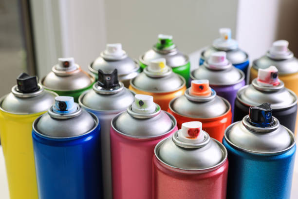 istock Cans of different graffiti spray paints on blurred background, closeup 1391591948