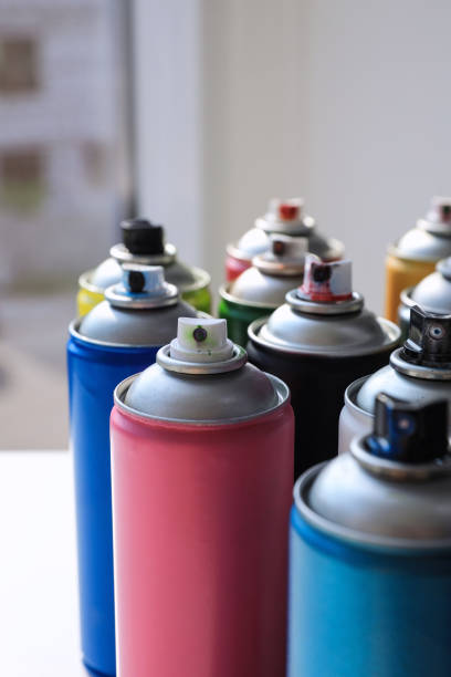 istock Cans of different graffiti spray paints on table, closeup 1391592470