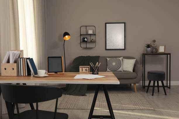istock Comfortable workplace with tablet on wooden table in modern office. Interior design 1391593599