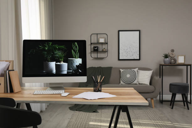 istock Comfortable workplace with computer on wooden desk in modern office. Interior design 1391593666