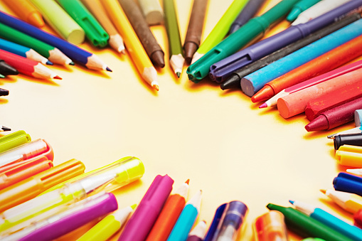 Art and drawing supplies, including pens, pencils and crayons, surround a blank space for your copy.