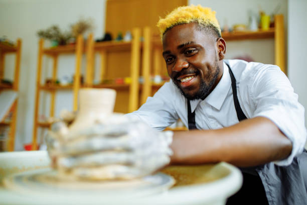 istock mixed race man making a vase in pottery studio 1391596588