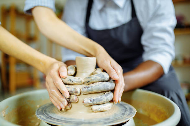 istock mixed race hands couple making vase in art studio 1391596593