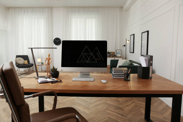 istock Workplace with computer on wooden desk in light room. Modern interior design 1391596734