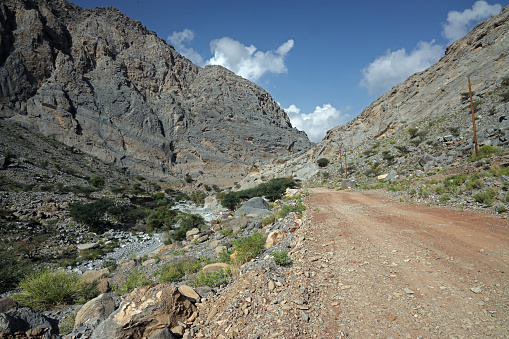 dirt road up dry rocky wadi