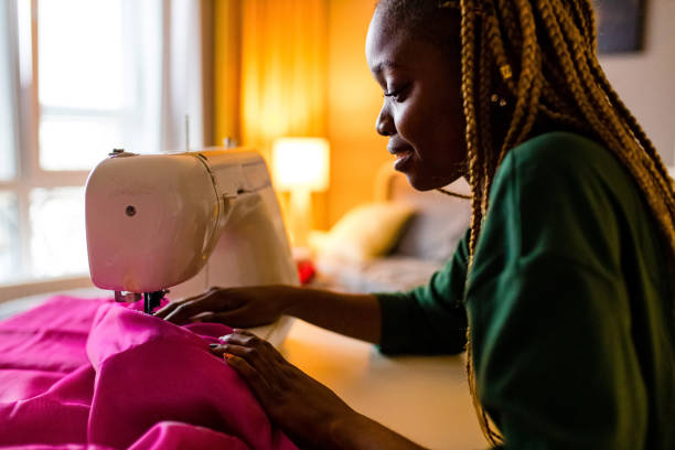 istock afro american stylist sewing all night long and feeking bad 1391596964