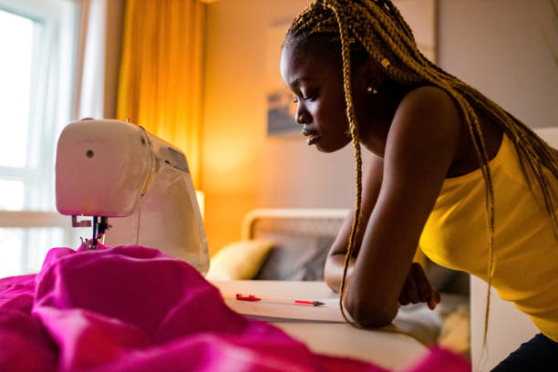 istock afro american stylist sewing all night long and feeking bad 1391596973
