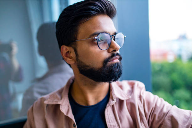 istock thoughtful indian man wearing glasses and looking away depression 1391598049