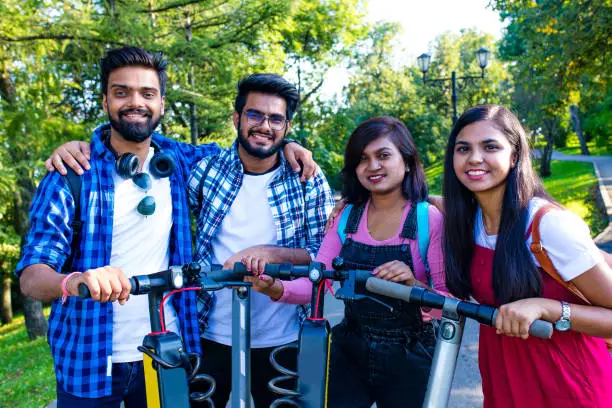 modern indian friends ride on segway in park in India.