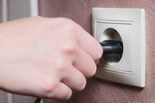 istock A female hand inserts an electric plug into a euro-format socket close-up 1391598167