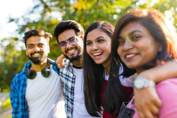 istock four people having fun outdoors, focus on beautiful indian woman 1391598172
