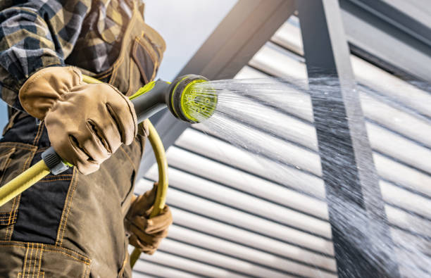 istock Men Watering His Backyard Lawn Using Garden Hose 1391599267