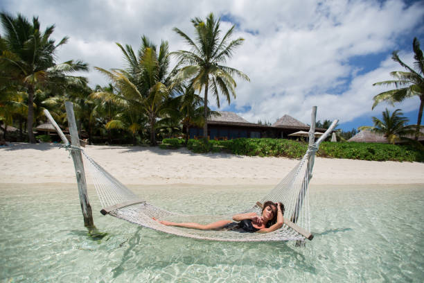 istock Woman in hammock on tropical beach at island 1391601335