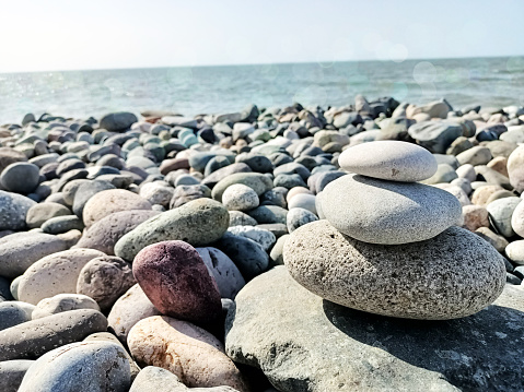 Zen style pebble on the beach with bokeh for background and inspiration