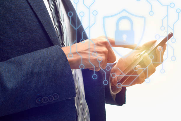 istock Cybersecurity Concept. Businessman holds cell phone with firewall icons. 1391606474