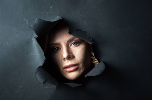 istock The girl's face appears on a black background. 1391606500