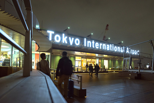 Tokyo, Japan - December 5, 2018: Illuminated Tokyo International Airport sign at observation deck of Haneda Airport International Passenger Terminal at night.