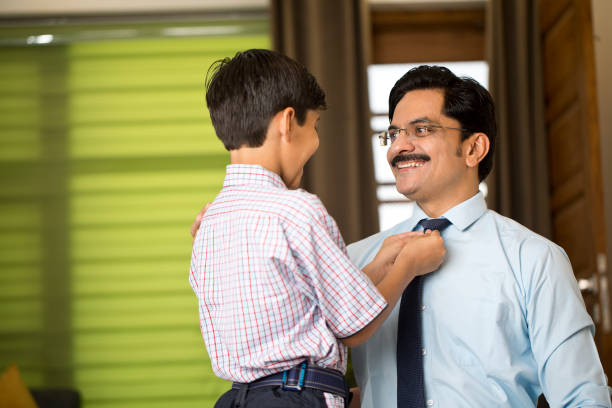 istock Happy boy adjusting necktie of his father while getting ready for office and school at home 1391608733