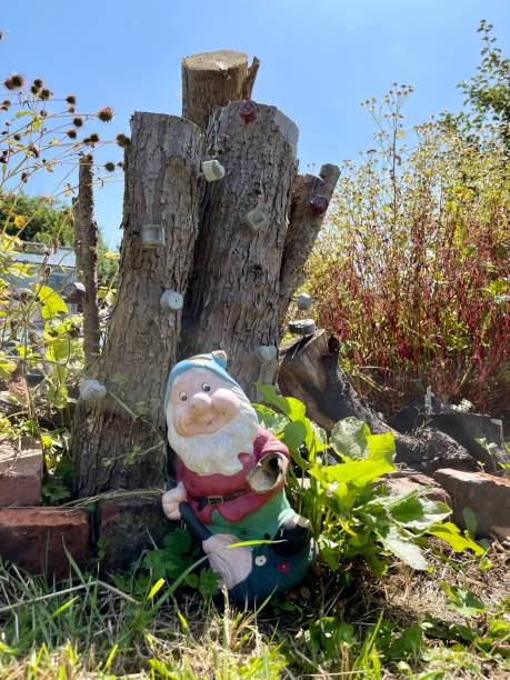 istock Garden gnome relaxing in the sunshine . 1391610474