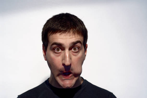 adult man making curious expressions with face on white background