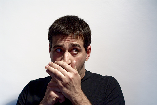 adult man making curious expressions with face on white background