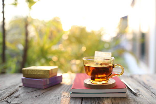 istock Tea in a glass cup and notebook and gift box 1391616116