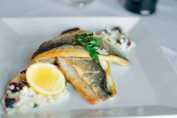 istock Fish dish - fish fillet and vegetables in restaurante 1391619074