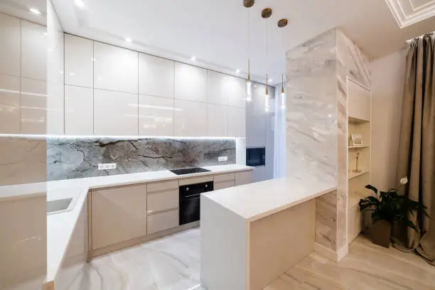 large clean new light kitchen with white furniture and lighting