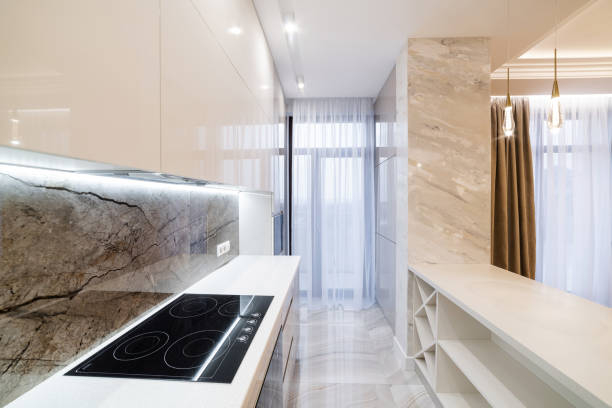 large clean new light kitchen with white furniture and lighting