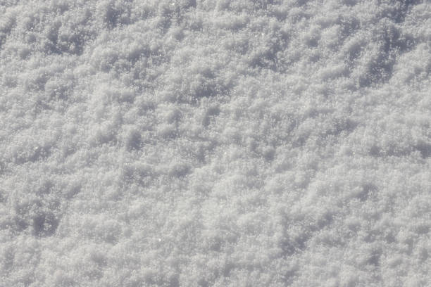 istock Beautiful winter background with snowy ground. Natural snow texture. Wind sculpted patterns on snow surface 1391625733