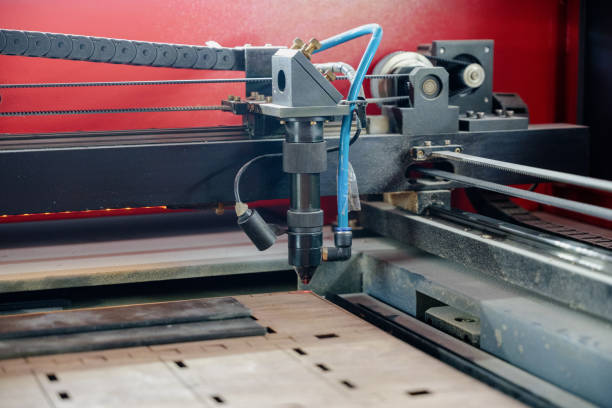 istock Laser cutting beam over plywood sheet 1391627164