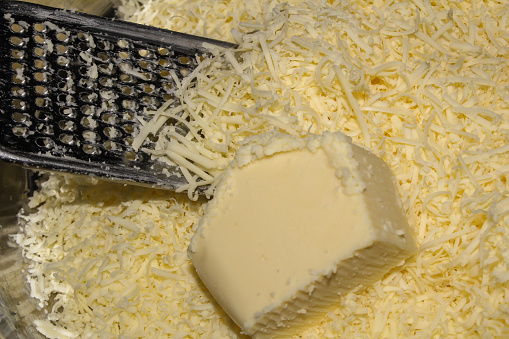 the cheese is almost completely grated and placed in a container