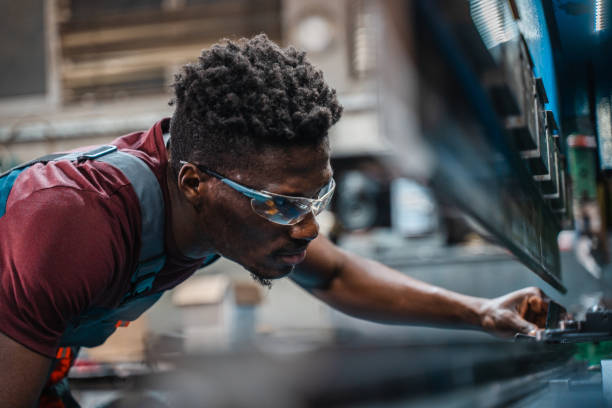 istock Afroamerican bluecollar worker in a factory 1391628624