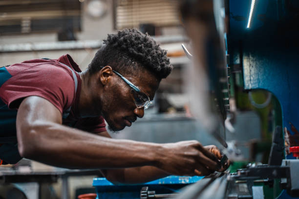 istock Afroamerican bluecollar worker in a factory 1391628634