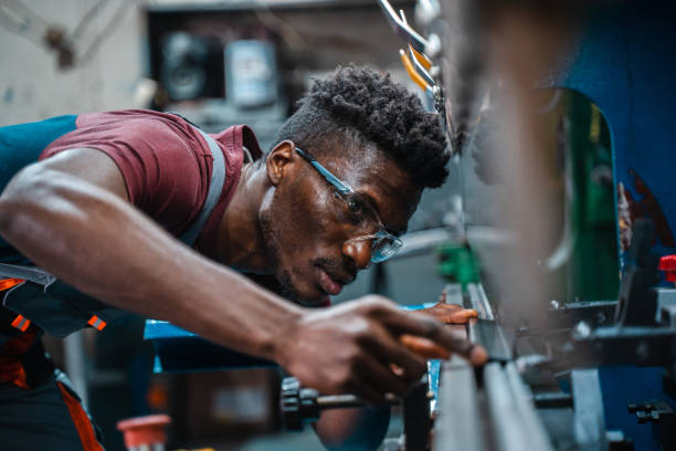 istock Afroamerican bluecollar worker in a factory 1391628663