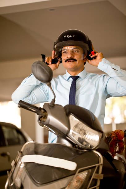 istock Happy man adjusting motorcycle helmet before leaving for office 1391629449