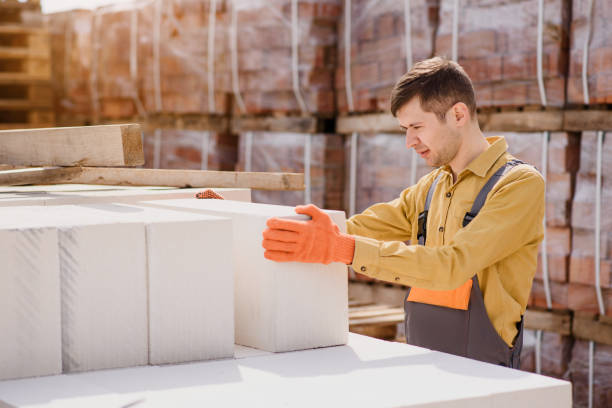 istock man contractor builder is holding an autoclaved aerated concrete block aac on a construction site. 1391629836