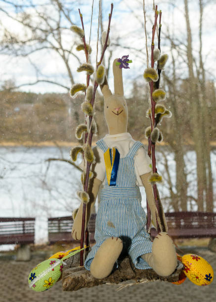istock Easter decor with Easter bunny on a swing, decorated with eggs and birds 1391634141