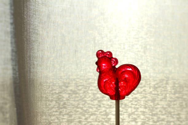 Transparent lollipop red cockerel on a stick