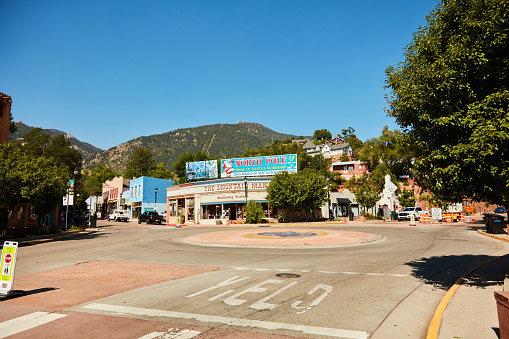 Manitou Springs, Colorado, USA - 20 August 2021: A roundabout flanked with old fashioned stores in the historic city of Manitou Springs in Colorado Springs.